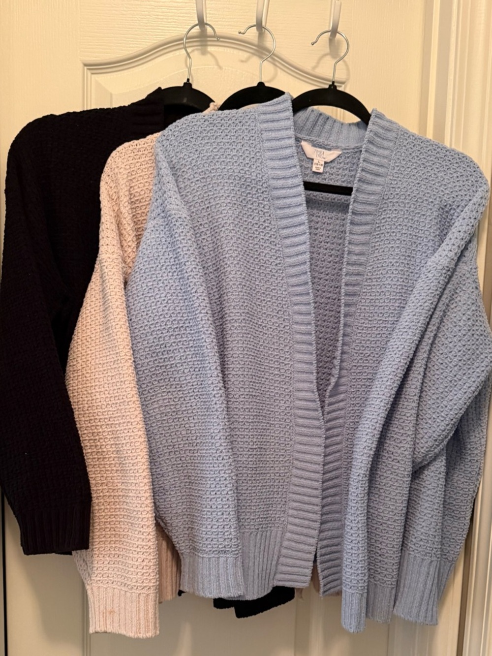 Three Time and Tru cardigans one light blue, one cream, and one black